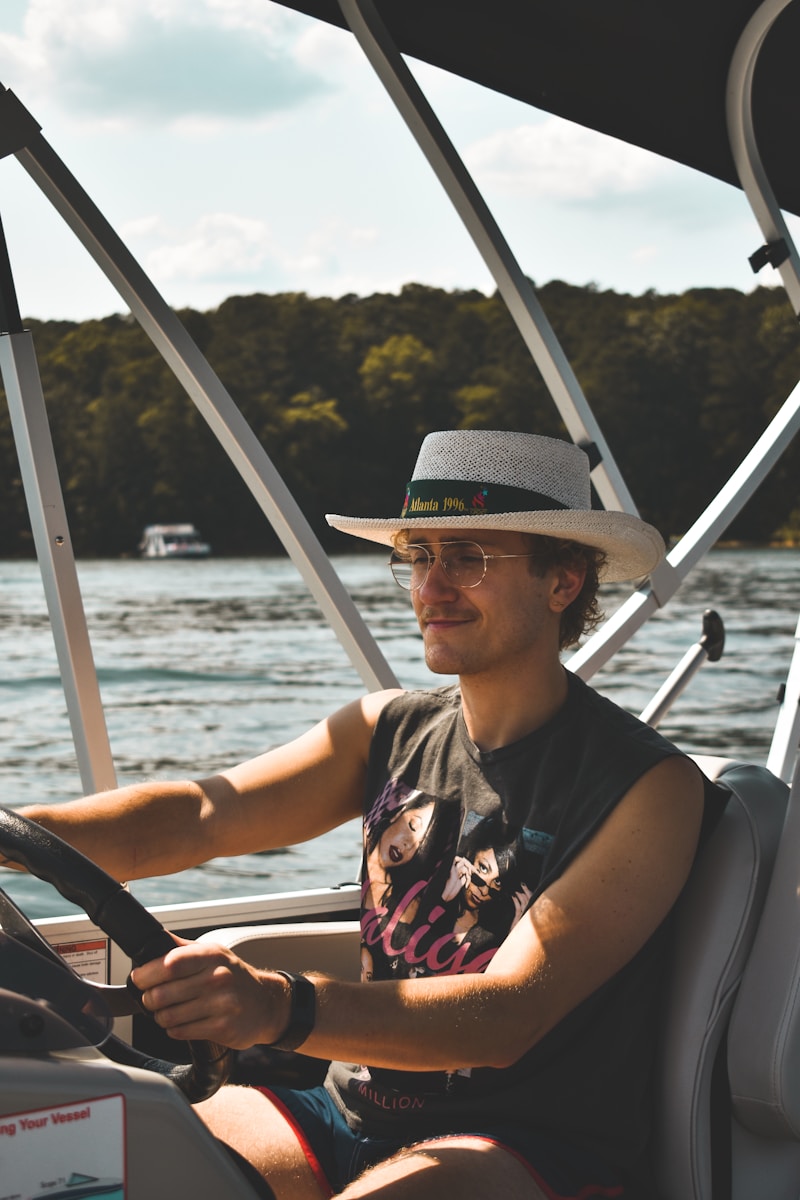 a man driving a boat on a body of water who happens to need underinsured boater coverage